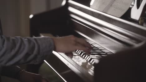 close-up-of-young-man-playing-piano-in-all-by-himself