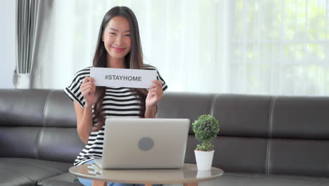 Young-Asian-woman-shows-hashtag-stay-home-message-for-Corona-pandemic