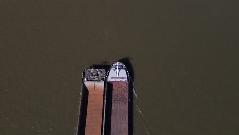 Bird's-eye-view-of-Empty-Cargo-Boat-entering-frame,-Cologne-Germany