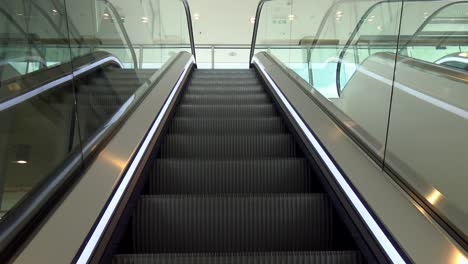 A-sideways-dolly-shot-of-an-escalator-going-up
