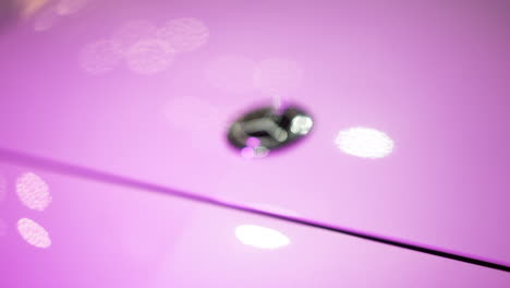 Mercedes-Benz-Amg-hood-closeup-of-the-star-logo-in-pink-light