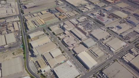 Aerial-view-of-Dammam-1st-industrial-city-with-warehouses,-factories,-and-heavy-machinery