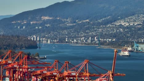 Hubschrauber-Fliegt-über-Den-Burrard-Inlet-Mit-Lions-Gate-Bridge-Im-Hintergrund-In-Vancouver,-Kanada