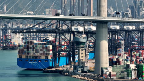 White-navigation-radar-is-turning-on-the-port-control-tower-while-in-the-Cosco-Portugal-is-moored-behind-the-suspension-bridge-at-ACT-container-terminal