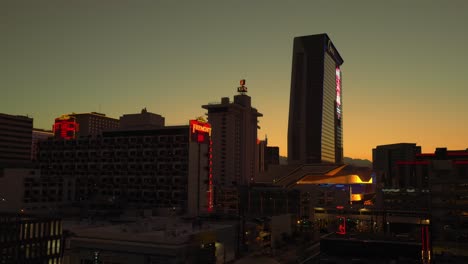 Tall-towers-on-Fremont-street-are-illuminated-by-sunset-and-city-lights