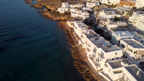 Epic-drone-shot-of-flying-away-from-Naoussa-village-towards-the-sea-on-the-island-of-Paros,-Greece