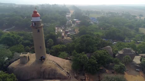 Light-house-of-mamallapuram-situated-among-famous-Rock-cut-Pallava-era-temples,-aerial-view-shot-on-Phantom-4-pro-4K-drone