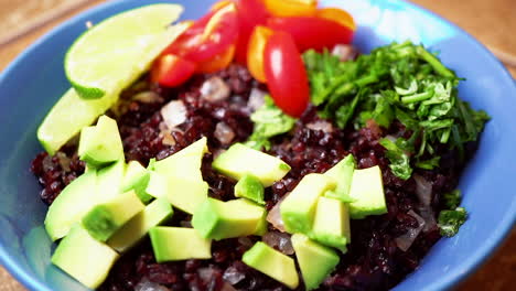 Homemade-protein-salad-bowl-with-black-rice,-avocado,-tomatoes-and-basil---vegan-vegetarian-delight