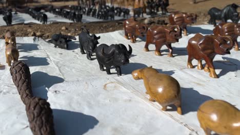 Tracking-shot-of-hand-made-African-animal-sculptures-at-African-market