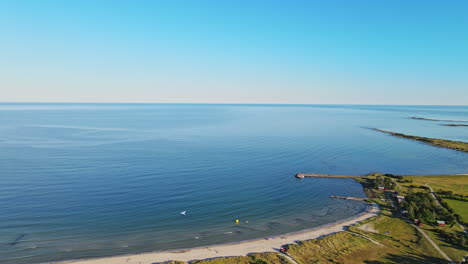 Peaceful-beach-and-blue-waves-of-Sandbybadet,-Öland,-Sweden---Aerial