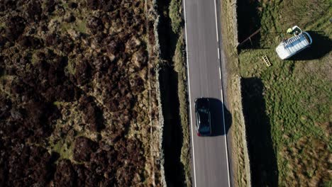 Top-down-view-of-a-car-on-a-rural-road-in-Derbyshire,-UK