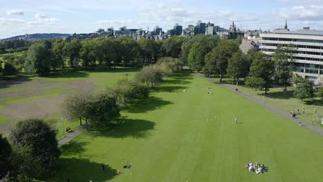 An-aerial-shot-moving-across-the-meadows-in-Edinburgh,-on-a-sunny-Summer-day