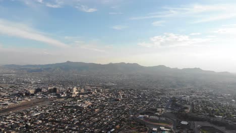 Aerial-drone-shot-of-El-Paso,-Texas,-looking-across-the-US-Mexico-border-and-into-Juarez,-Mexico