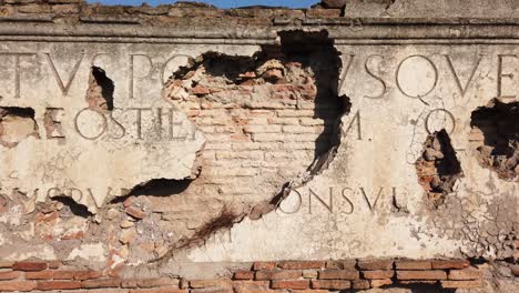 The-inscription-originally-placed-on-the-main-gate-of-Ostia-antica,-a-world-famous-archeological-site-from-ancient-Rome