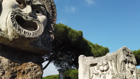 Theater-masks-from-the-decoration-of-the-amphitheater-in-Ostia-Antica,-a-huge-archaeological-site-located-in-Rome