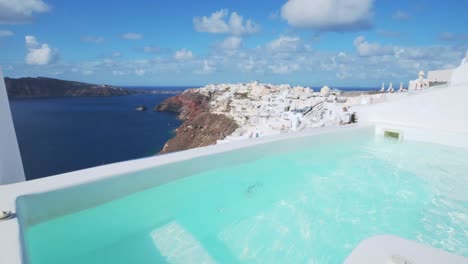 View-of-the-Jacuzzi-with-Oia-village-in-the-background,-Greece