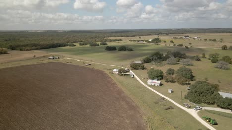 Farmland-flyover-in-western-Texas-on-a-sunny-day-with-some-clouds-about
