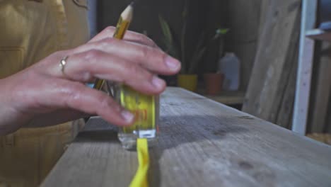 Workshop-woodworker-Measuring-wood-tape-measure-yellow