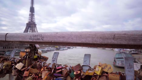 Love-padlocks-on-a-bridge-in-Paris-with-view-of-the-Eiffel-Tower,-romantic-symbols-in-Paris,-tourism-in-France