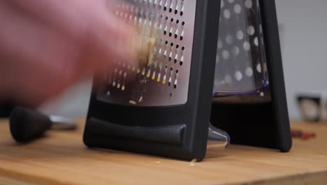 Person-Grating-Ginger-in-the-Kitchen,-Static-Close-up