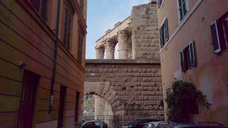 Walking-in-the-roman-district-of-Monti,-in-a-narrow-street-leading-to-Forum-of-Augustus-with-its-columns-from-ancien-Rome