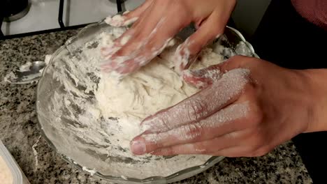 woman's-hands-kneading-dough-in-a-bowl