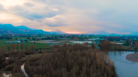 A-colorful-aerial-view-of-a-small-farm-beside-the-mountains