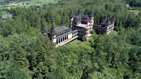 Fly-above-tree-tops-and-reveal-majestic-building-of-Lapalice-castle
