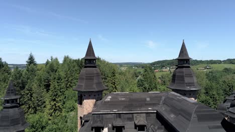 Abandon-Polish-castle-with-majestic-towers,-aerial-fly-extremely-close-up