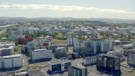 Drone-flight-over-Reykjavik---from-coast-line-over-business-district-to-school-in-city-center-that-looks-like-a-castle