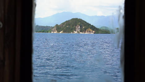 Forest-Valleys-View-From-The-Window-Of-A-Traveling-Tourist-Wooden-Boat-In-Komodo-Island,-Bali-Indonesia