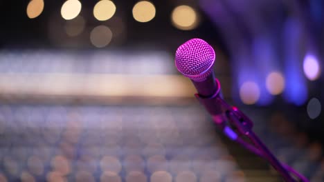 Microphone-unused-on-stage-in-an-empty-theatre,-stage-fright-feeling