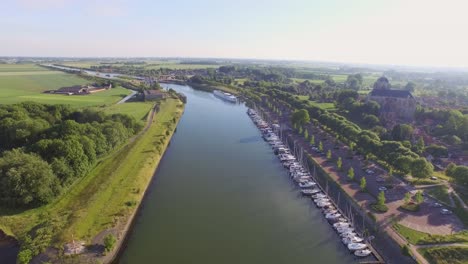 Aerial:-The-surroundings-and-the-historical-touristic-town-of-Veere,-the-Netherlands