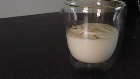 Pouring-Muesli-ontop-of-Yogurt-into-a-class-cup