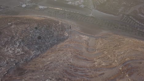 Aerial-view-of-a-barren-hill-going-to-the-town-of-Arraba-Palestine-Middle-East