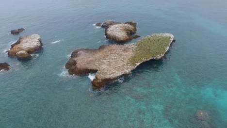 Aerial-tilt-up-shot-of-a-big-rock-formation,-Marietas-Islands,-Nayarit,-Mexico