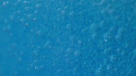 Close-up-footage-of-blue-fizzy-bubbles