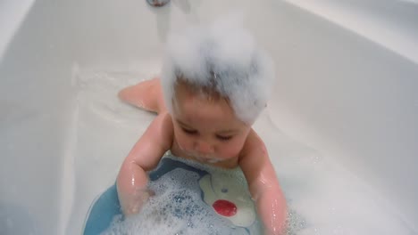 Cute-six-months-old-baby-boy-having-a-bath-on-his-tummy