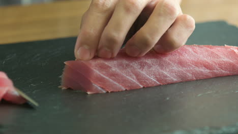Close-Up-Of-Fish-Meat-Being-Sliced