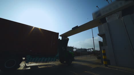A-Trucks-is-entering-into-the-port-gate,-A-long-vehicle-traller-is-moving-on-the-road-of-a-port,-camera-passing,-close-up-view