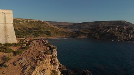 AERIAL:-Flying-next-to-the-cliffs-of-Għajn-Tuffieħa-Bay-in-Malta-during-Sunset
