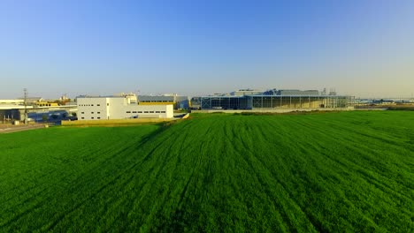 Rising-Above-Factory-in-front-of-a-green-Field
