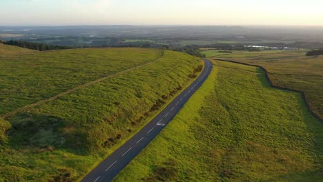 An-aerial-shot-of-an-empty-road-in-the-English-countryside