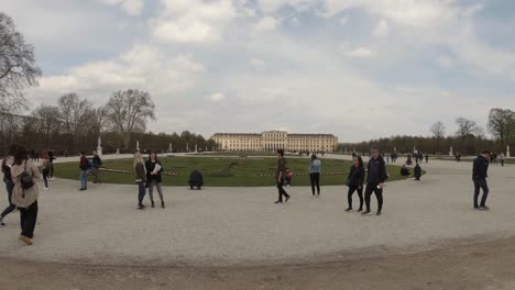 The-Schönbrunn-gardens-with-the-Palace-in-the-distance,-full-of-tourists