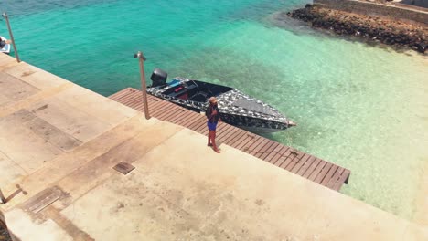 Epic-aerial-of-a-couple-enjoying-the-beach-at-Petit-St-Vincent,-St-Vincent