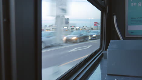 Editorial,-4K-through-a-bus-window-view-filmed-by-a-passenger-while-the-bus-is-moving