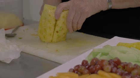 Slicing-a-fresh-pineapple-for-a-fruit-platter