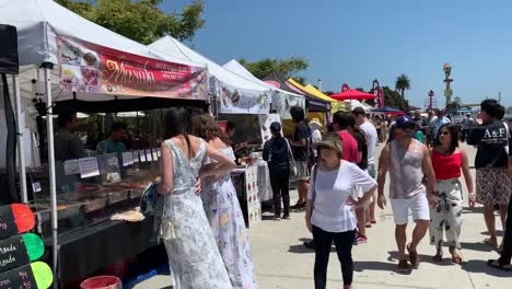 Local-vendors-selling-food-at-the-Ruocco-Park-Market,-located-on-a-stunning-waterfront-park-right-on-the-Embarcadero-between-Seaport-village-and-the-USS-Midway-in-Downtown-San-Diego