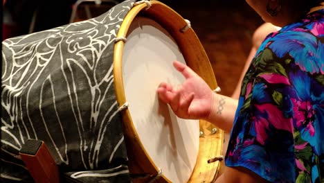 tight-shot-of-a-lady-hand-playing-a-big-Pacific-Island-drum-on-Stage