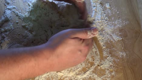 Dough-Being-Kneaded-on-a-Wooden-Work-Surface-for-Baking
